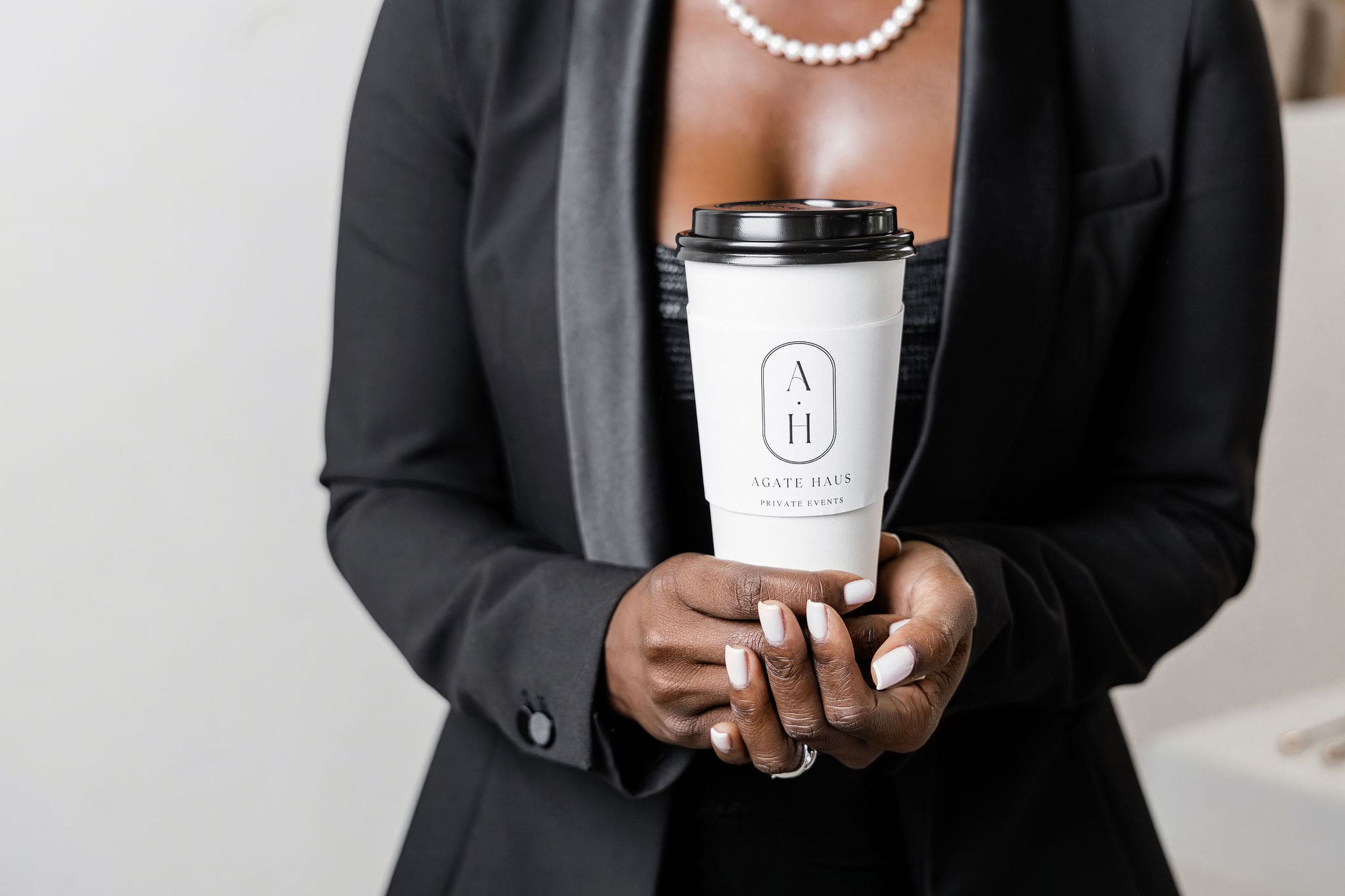 Woman holding Agate Haus Private Events coffee cup